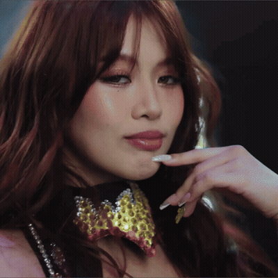 A Close Up Of A Woman Wearing A Choker And A Bow Tie GIF