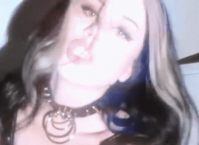 A Close Up Of A Woman Wearing A Choker And A Necklace . GIF