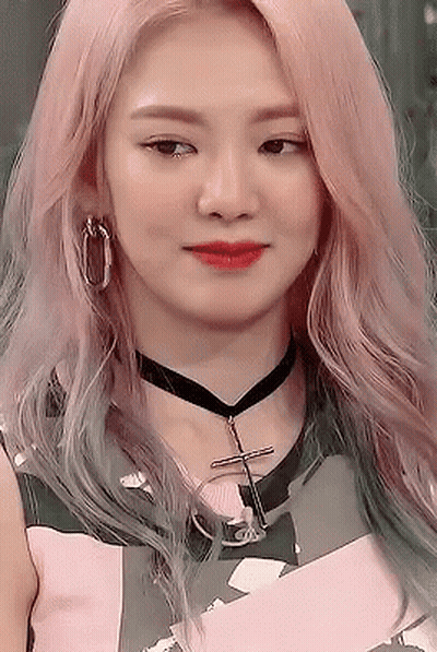 A Close Up Of A Woman Wearing A Choker And Earrings . GIF