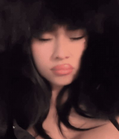 A Close Up Of A Woman Wearing A Fur Hat Making A Funny Face . GIF