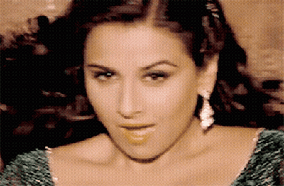 A Close Up Of A Woman Wearing A Green Dress GIF