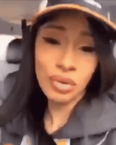 A Close Up Of A Woman Wearing A Hat And Making A Funny Face . GIF