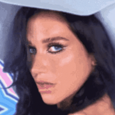 A Close Up Of A Woman Wearing A Hat GIF