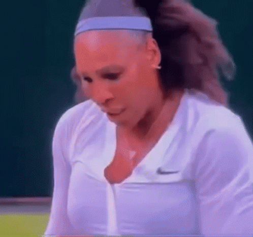 A Close Up Of A Woman Wearing A Headband And A White Shirt . GIF