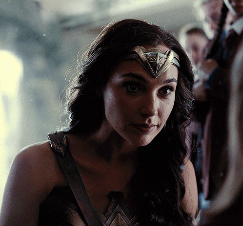 A Close Up Of A Woman Wearing A Headband With A Triangle On It GIF