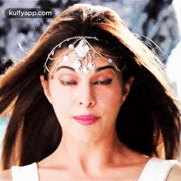 A Close Up Of A Woman Wearing A Headpiece And Making A Funny Face . GIF