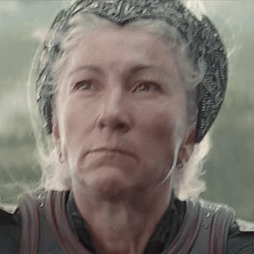 A Close Up Of A Woman Wearing A Helmet And A Crown . GIF