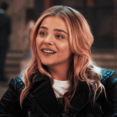 A Close Up Of A Woman Wearing A Leather Jacket GIF