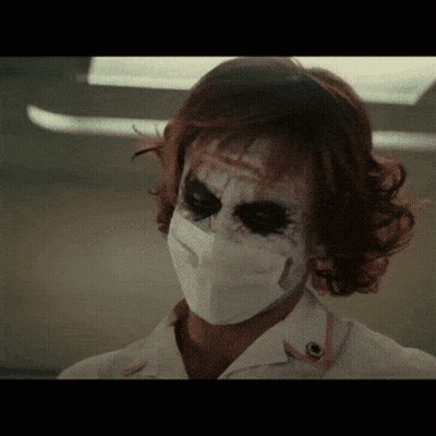 A Close Up Of A Woman Wearing A Mask GIF