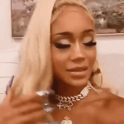A Close Up Of A Woman Wearing A Necklace And Earrings . GIF