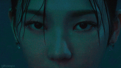 A Close Up Of A Woman Wearing A Necklace That Says ' N ' On It GIF