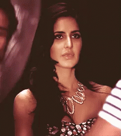 A Close Up Of A Woman Wearing A Necklace GIF