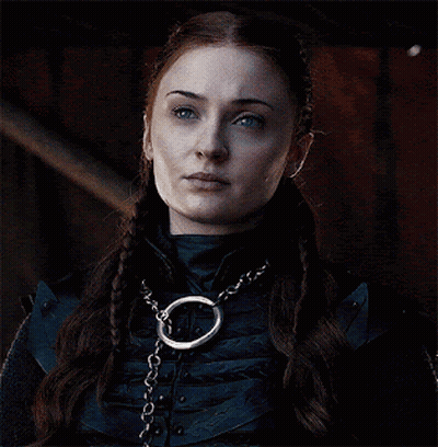 A Close Up Of A Woman Wearing A Necklace With A Chain Around Her Neck GIF