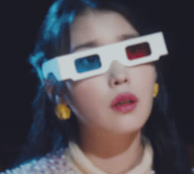 A Close Up Of A Woman Wearing A Pair Of 3D Glasses . GIF