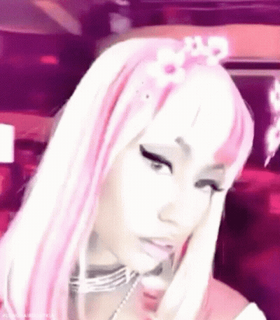 A Close Up Of A Woman Wearing A Pink And White Wig And A Flower In Her Hair . GIF