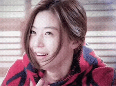 A Close Up Of A Woman Wearing A Red And Blue Blanket GIF