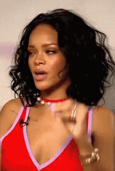 A Close Up Of A Woman Wearing A Red And Purple Top GIF