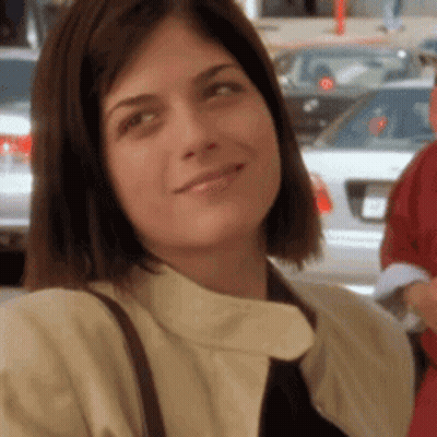 A Close Up Of A Woman Wearing A Tie And A Jacket GIF