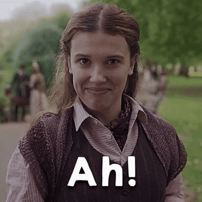 A Close Up Of A Woman Wearing A Vest And Smiling With The Words Ah ! GIF