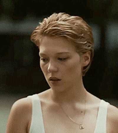 A Close Up Of A Woman Wearing A White Tank Top And Necklace GIF