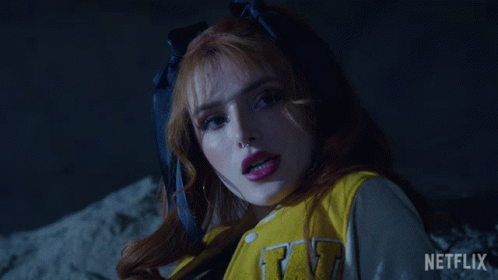 A Close Up Of A Woman Wearing A Yellow Jacket With The Letter W On It GIF