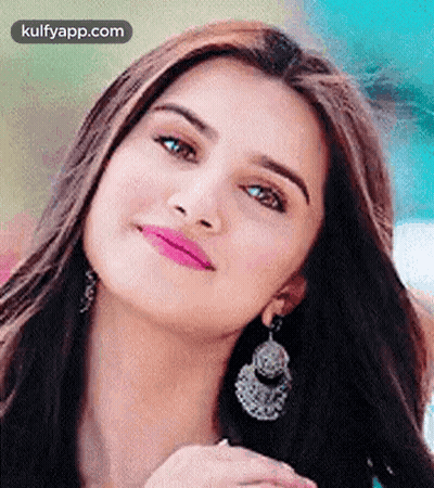 A Close Up Of A Woman Wearing Earrings And A Pink Lip Gloss . GIF