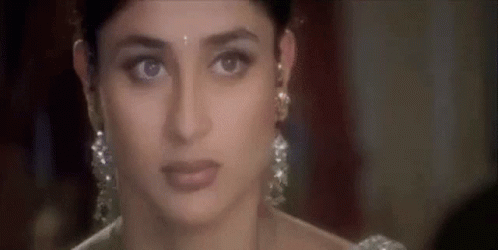 A Close Up Of A Woman Wearing Earrings And A White Dress . GIF