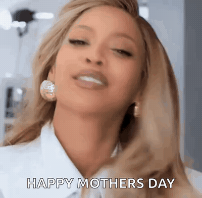 A Close Up Of A Woman Wearing Earrings And A White Shirt . GIF