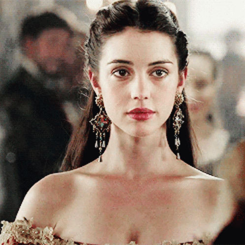 A Close Up Of A Woman Wearing Earrings GIF