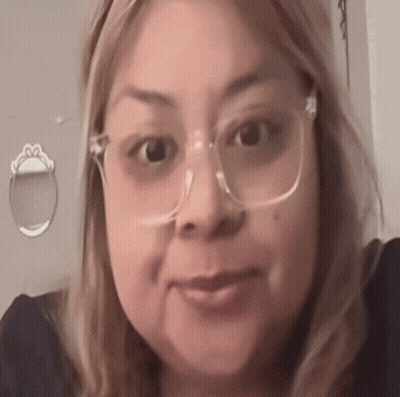 A Close Up Of A Woman Wearing Glasses And A Black Shirt . GIF