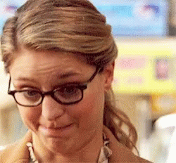 A Close Up Of A Woman Wearing Glasses And A Brown Coat GIF