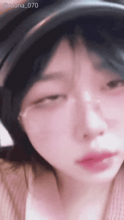 A Close Up Of A Woman Wearing Glasses And A Hat With The Number 70 On The Bottom GIF