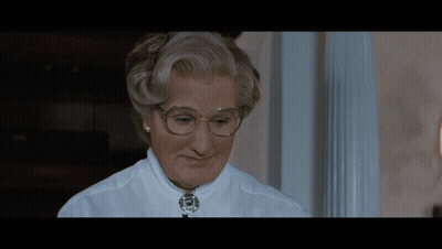 A Close Up Of A Woman Wearing Glasses And A Necklace GIF