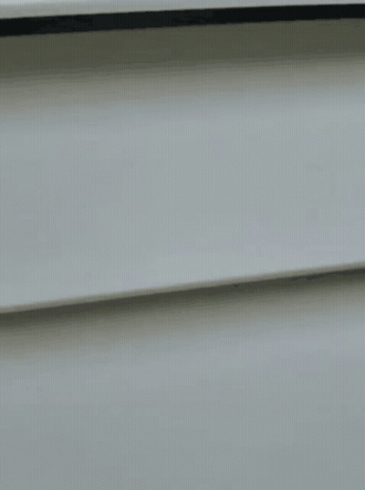 A Close Up Of A Woman Wearing Glasses Looking Out Of A Window GIF