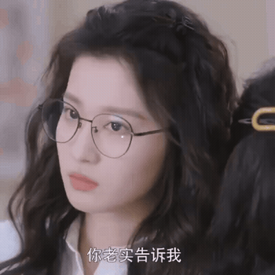 A Close Up Of A Woman Wearing Glasses With Chinese Writing GIF