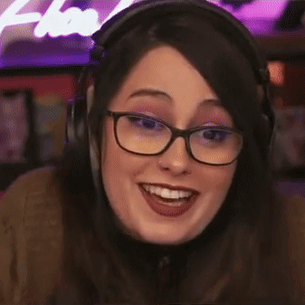 A Close Up Of A Woman Wearing Headphones And Glasses Smiling . GIF