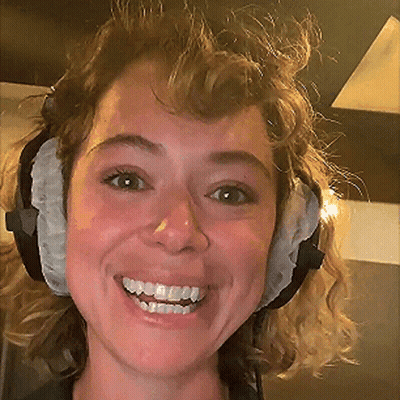 A Close Up Of A Woman Wearing Headphones Smiling GIF