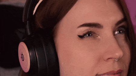 A Close Up Of A Woman Wearing Headphones With The Letter O On The Side GIF
