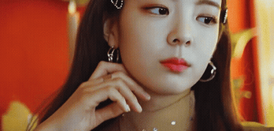 A Close Up Of A Woman Wearing Hoop Earrings And A Choker GIF