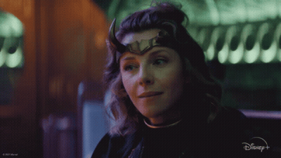 A Close Up Of A Woman Wearing Horns And A Disney Logo GIF