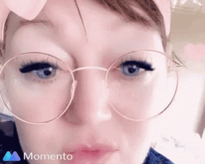 A Close Up Of A Woman Wearing Round Glasses GIF