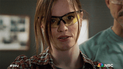 A Close Up Of A Woman Wearing Safety Glasses With A Nbc Logo In The Background GIF