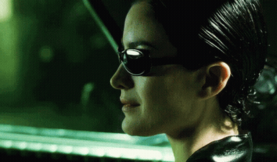 A Close Up Of A Woman Wearing Sunglasses And A Black Jacket GIF