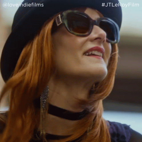A Close Up Of A Woman Wearing Sunglasses And A Hat With The Hashtag #Jtleroyfilm GIF