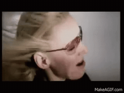A Close Up Of A Woman Wearing Sunglasses And A Ponytail . GIF