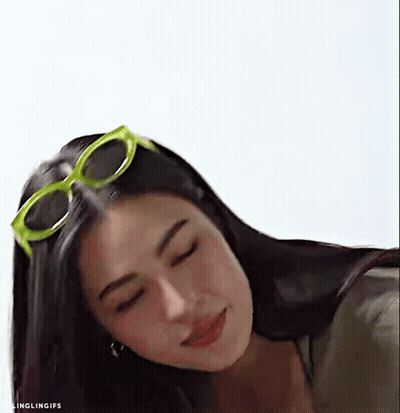 A Close Up Of A Woman Wearing Sunglasses And Looking Down . GIF
