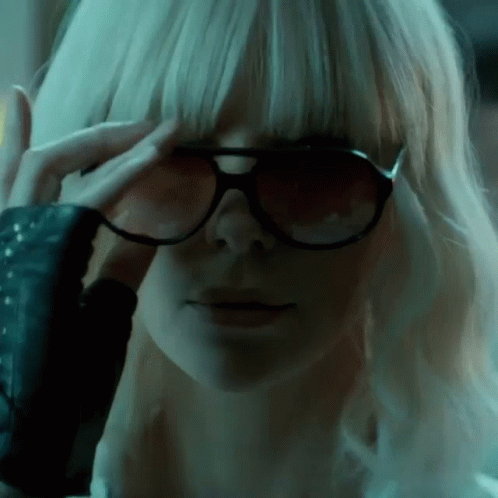 A Close Up Of A Woman Wearing Sunglasses Covering Her Eyes GIF