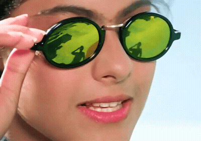 A Close Up Of A Woman Wearing Sunglasses With A Reflection Of A Person GIF