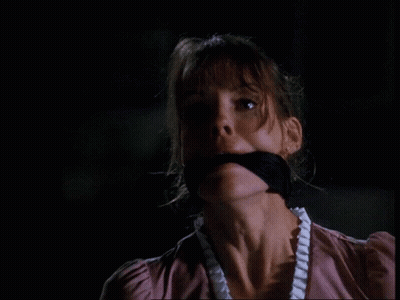 A Close Up Of A Woman With A Black Bandage Around Her Mouth GIF