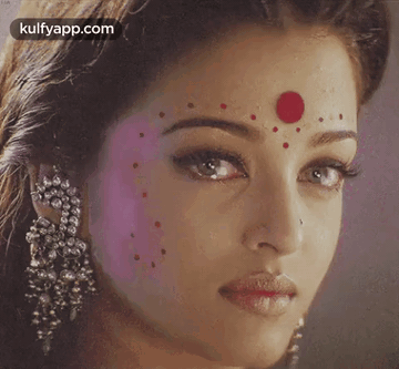 A Close Up Of A Woman With A Red Dot On Her Forehead GIF